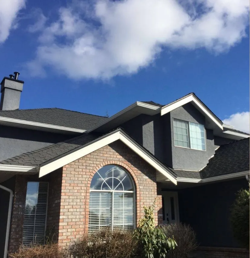 Brick home with a newly completed cedar shingle roof